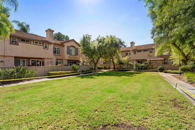 a front view of a building with a yard