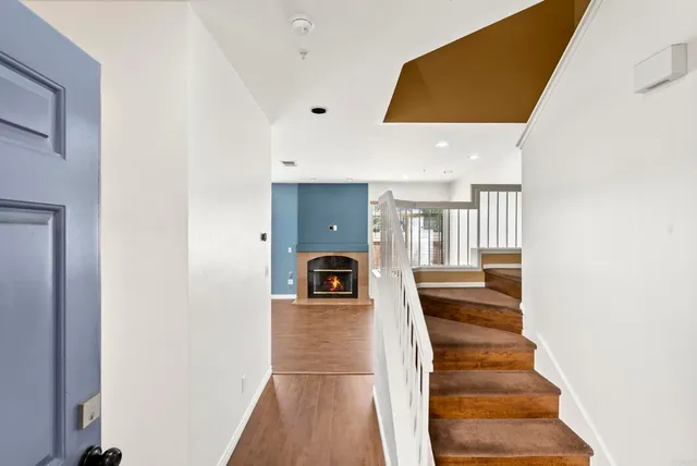 a view of entryway and hall with wooden floor
