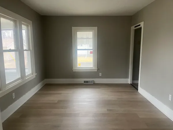 a view of an entryway with wooden floor