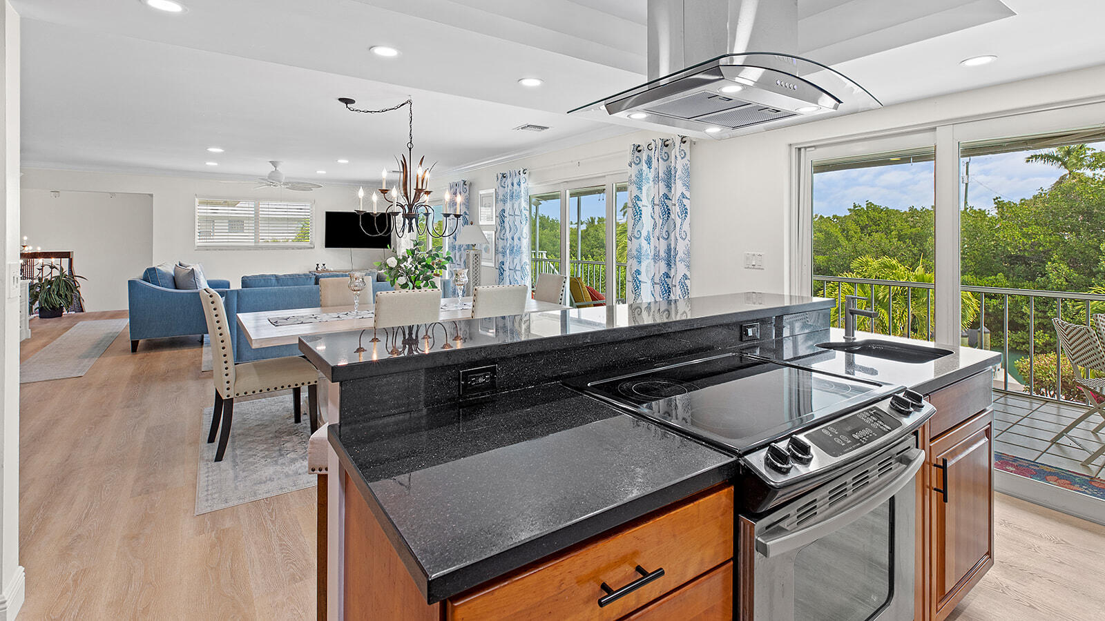 220 15th Circle Key Colony Beach, FL 33051 - Photo 11 of 43 a kitchen with a stove a sink a counter top space and a window