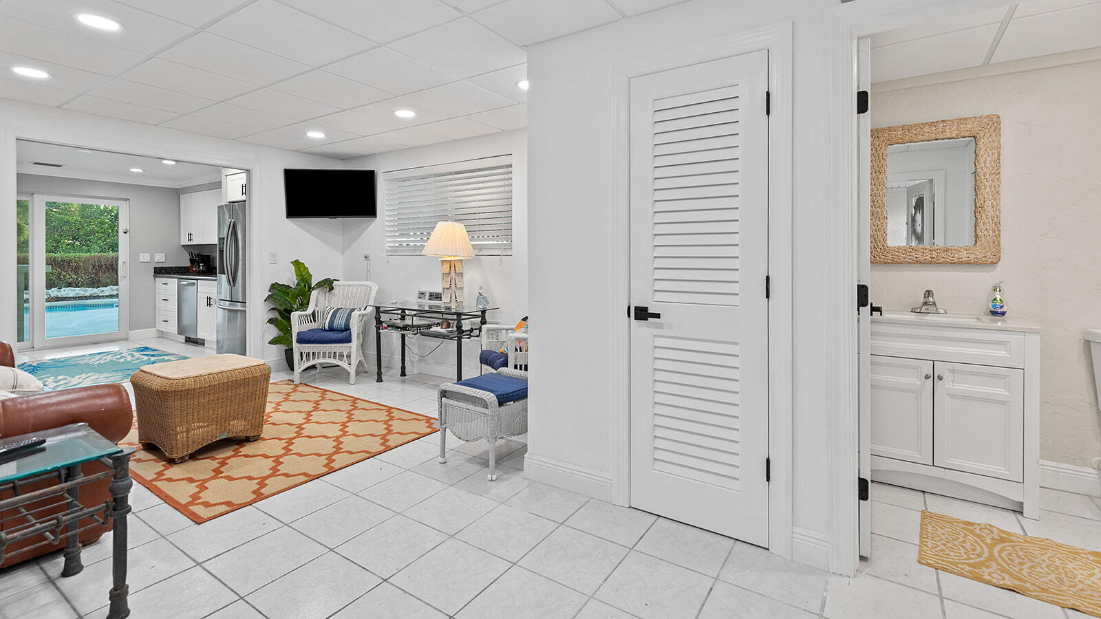 220 15th Circle Key Colony Beach, FL 33051 - Photo 28 of 43 a living room with furniture a flat screen tv and kitchen view