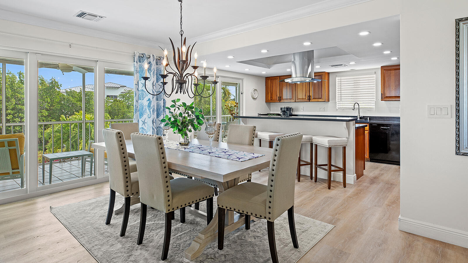 220 15th Circle Key Colony Beach, FL 33051 - Photo 8 of 43 a dining room filled chandelier and wooden floor