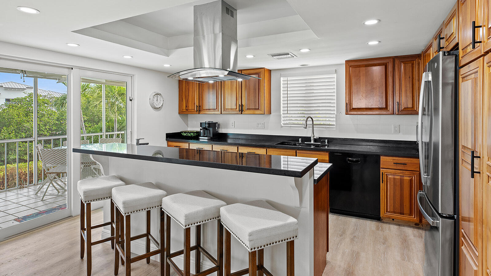 220 15th Circle Key Colony Beach, FL 33051 - Photo 9 of 43 a kitchen with granite countertop a sink a counter top space and stainless steel appliances