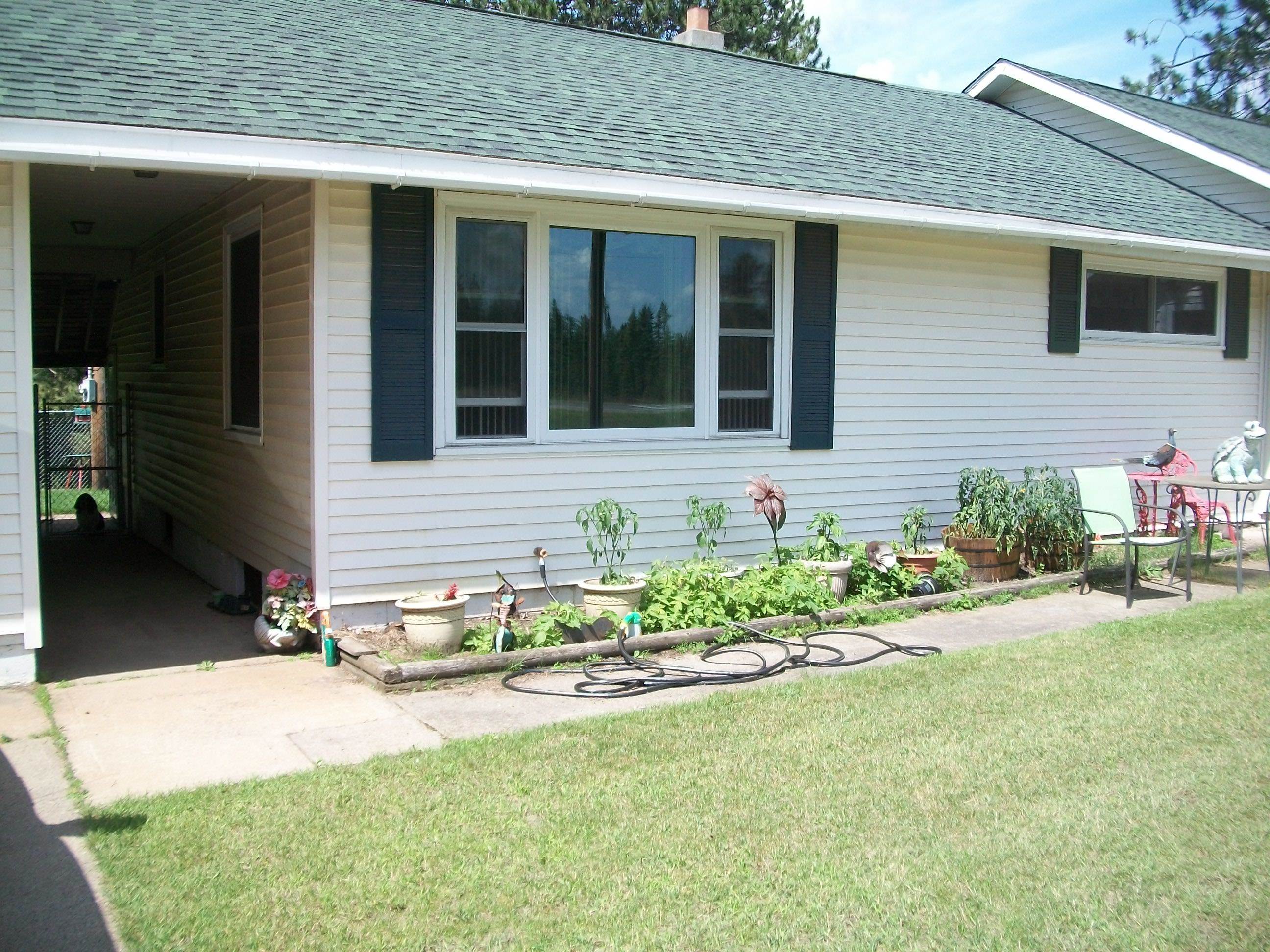 3917 Highway 5 Hibbing, MN 55746 - Photo 2 of 36 View of home's exterior featuring roof with shingles and a lawn