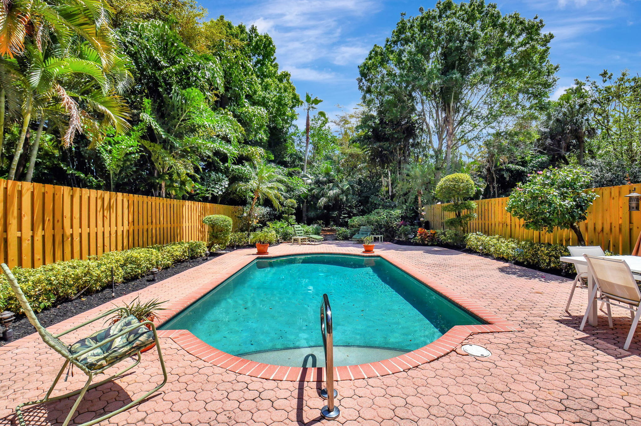 a view of swimming pool with a lounge chairs