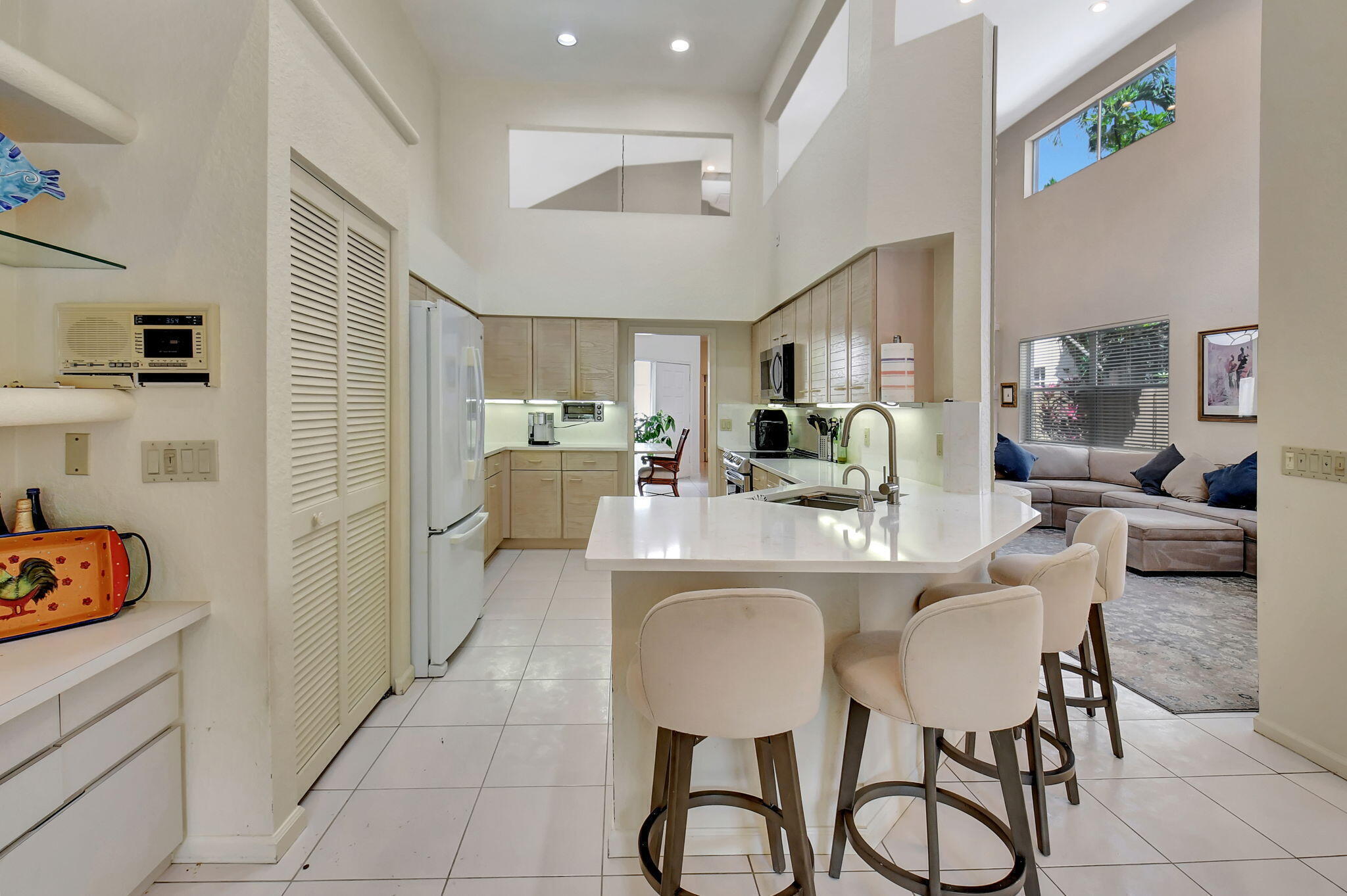 2462 Northwest 66th Drive Boca Raton, FL 33496 - Photo 16 of 49 a dining room with furniture and a kitchen area