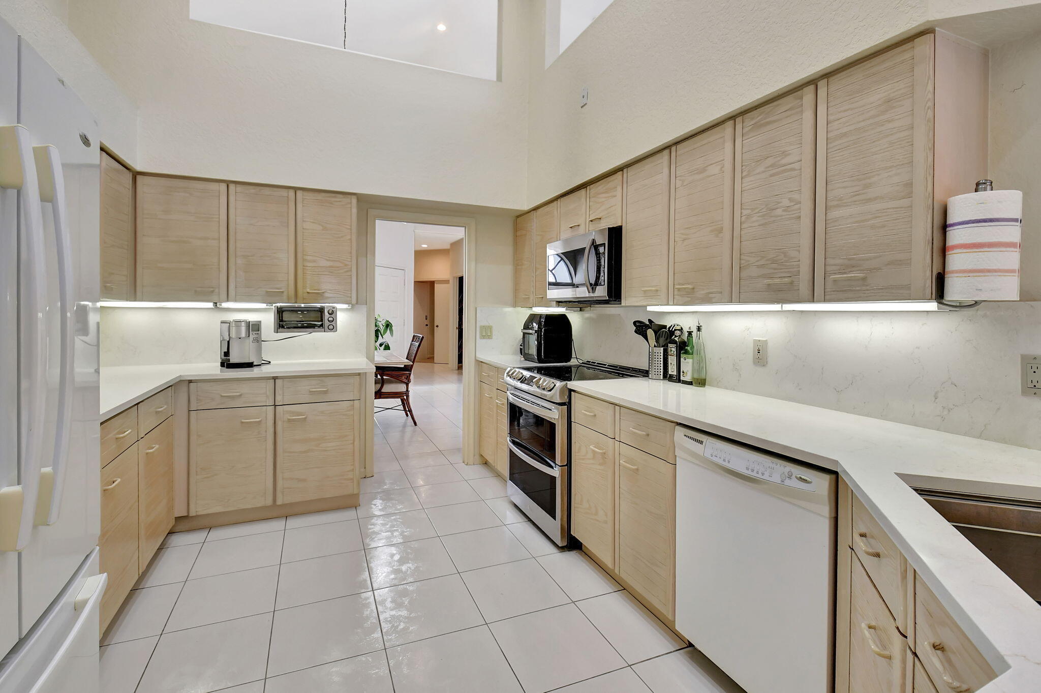 2462 Northwest 66th Drive Boca Raton, FL 33496 - Photo 17 of 49 a kitchen with a stove sink and cabinets