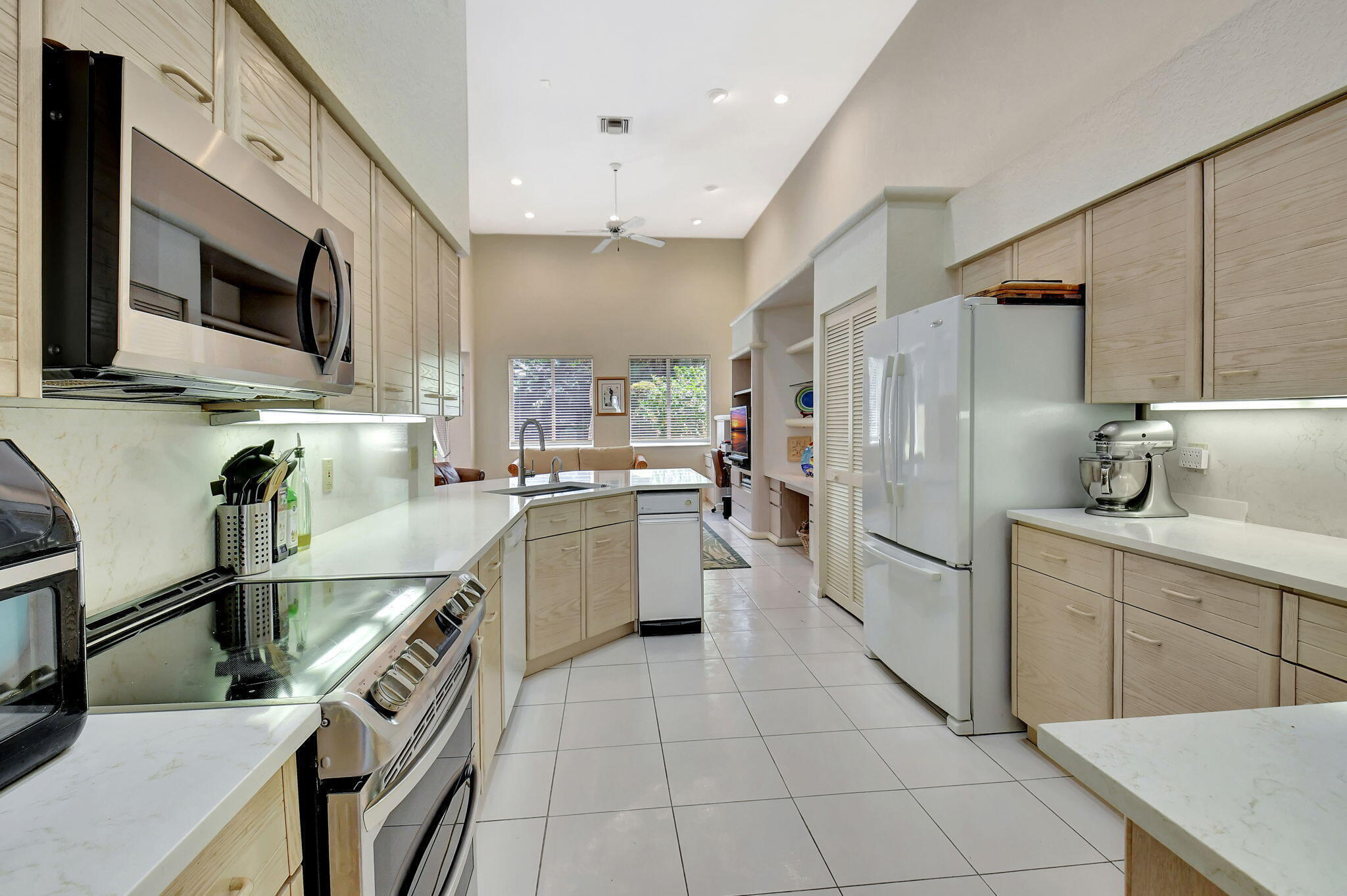 2462 Northwest 66th Drive Boca Raton, FL 33496 - Photo 19 of 49 a kitchen with a sink stainless steel appliances and cabinets