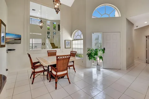 a dining room with furniture and a chandelier