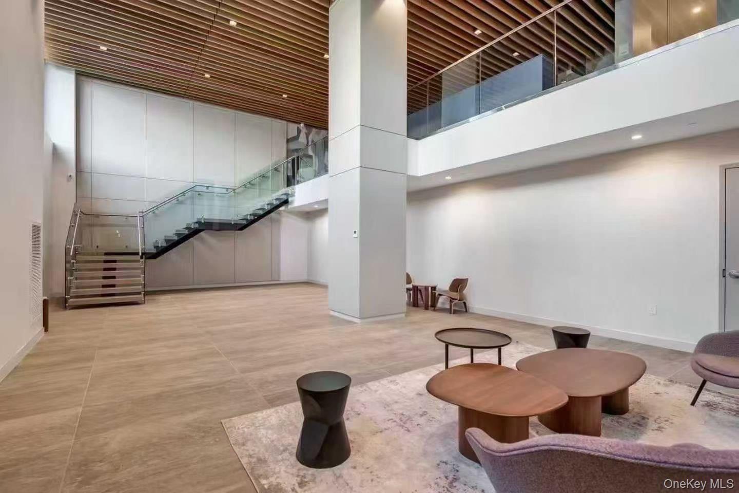 131-02 40th Road, Unit 4U Queens, NY 11354 - Photo 2 of 10 Common area featuring a towering ceiling, stairway, and recessed lighting