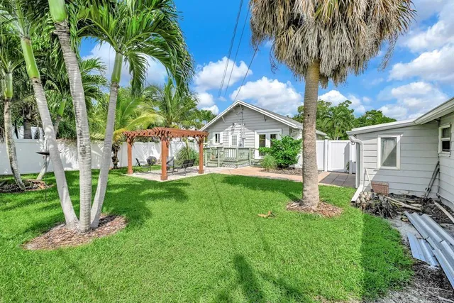 a view of backyard of house with green space