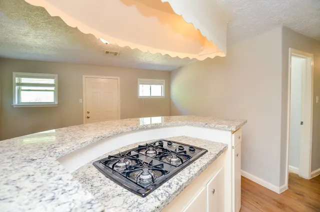 a stove top oven sitting inside of a kitchen