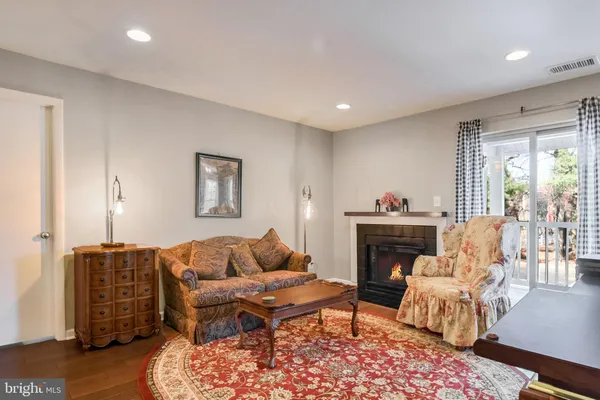 a living room with furniture a fireplace and a table