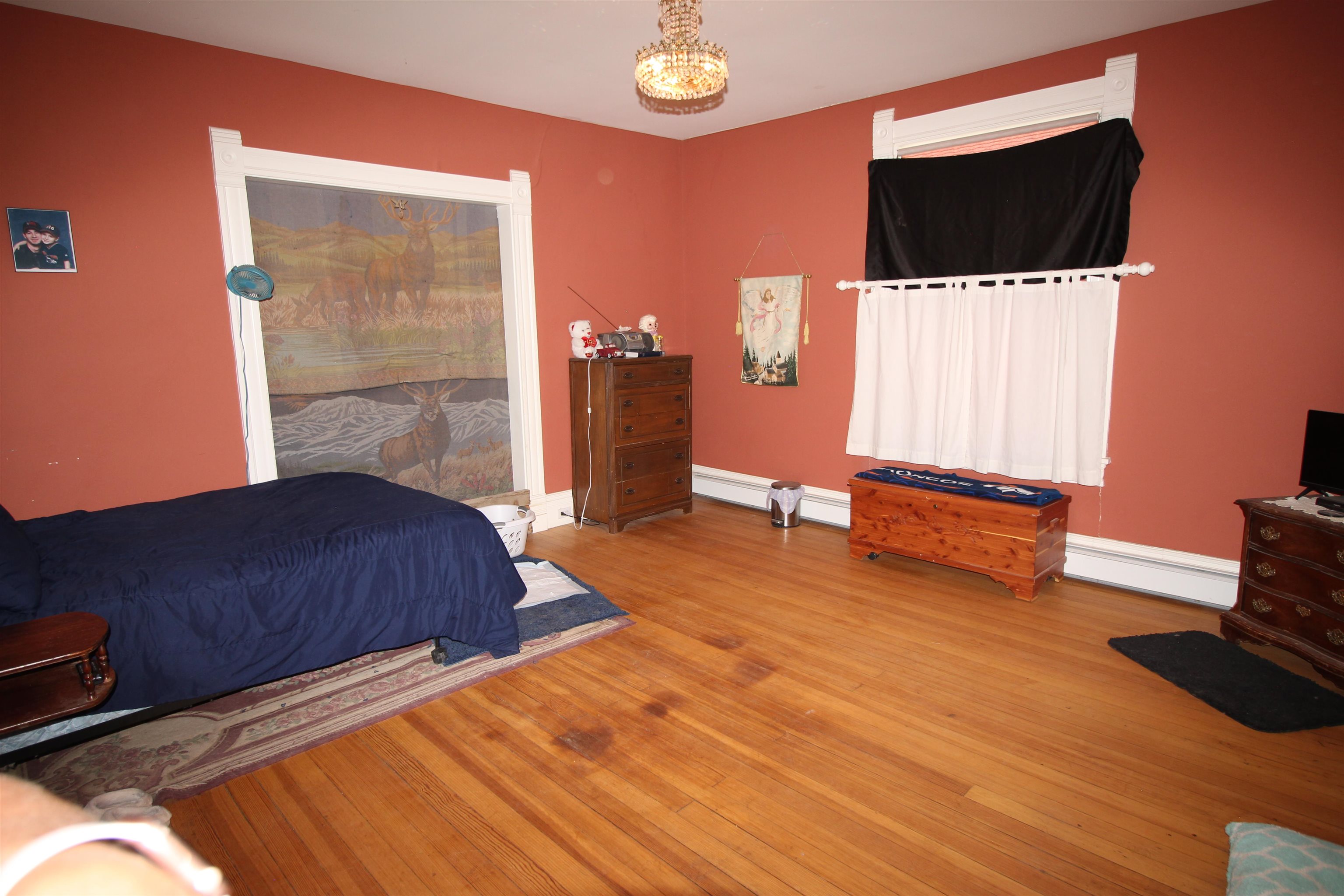 1150 East 7th Street Delta, CO 81416 - Photo 5 of 32 a bedroom with a bed and a television