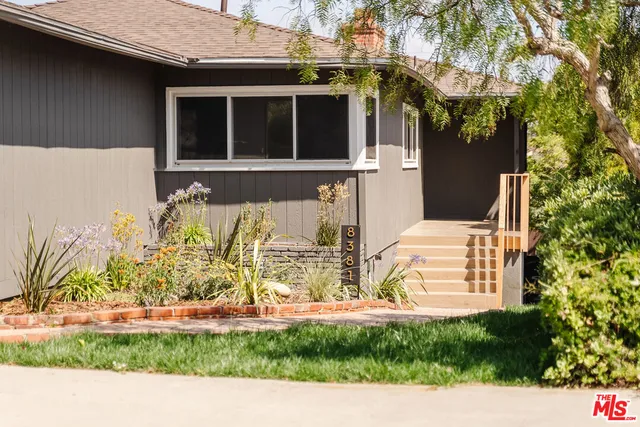 a kitchen with granite countertop a stove oven and white cabinets
