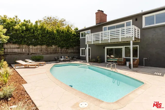 a bathroom with a sink a bathtub a mirror a vanity and a shower