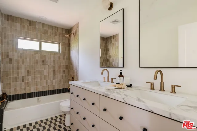 a kitchen with a stove and white cabinets