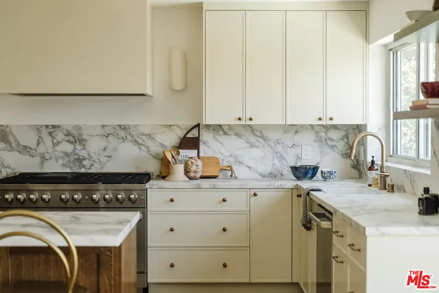 a kitchen with stove and cabinets