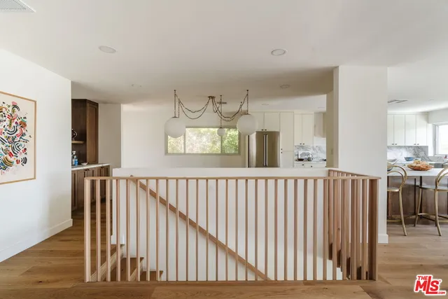 a view of hallway with furniture and windows