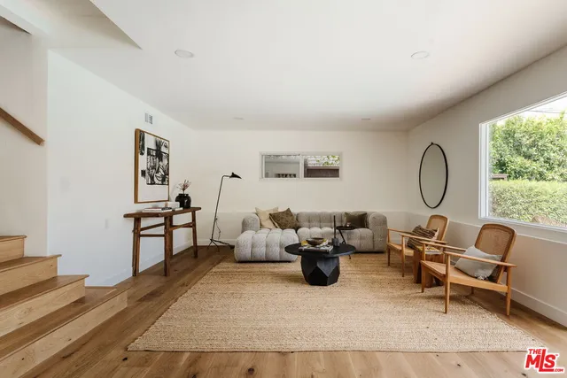a living room with furniture rug and a window