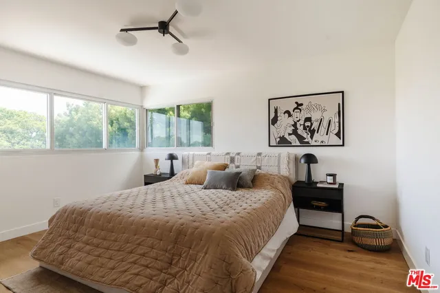 a bedroom with double bed and a window