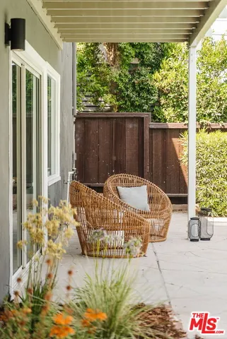 a white bed sitting in front of a house