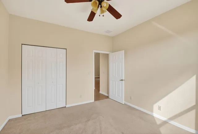 a view of livingroom with furniture and chandelier fan