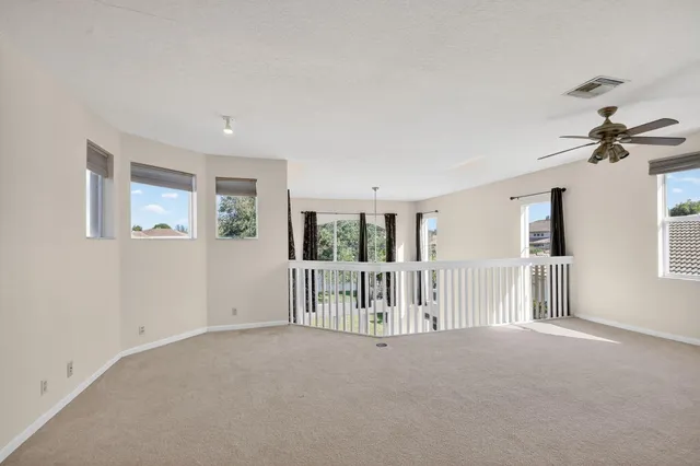 a bathroom with a sink a toilet a window and a mirror