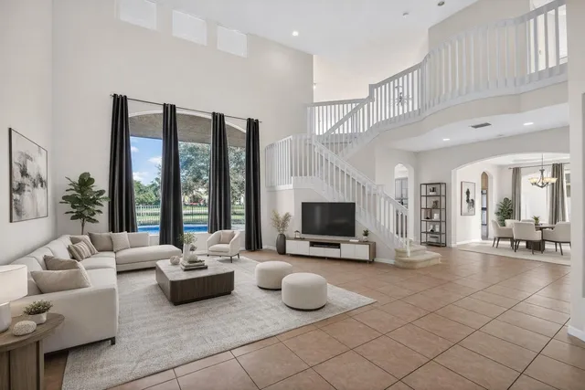 a view of a kitchen with white cabinets and entryway