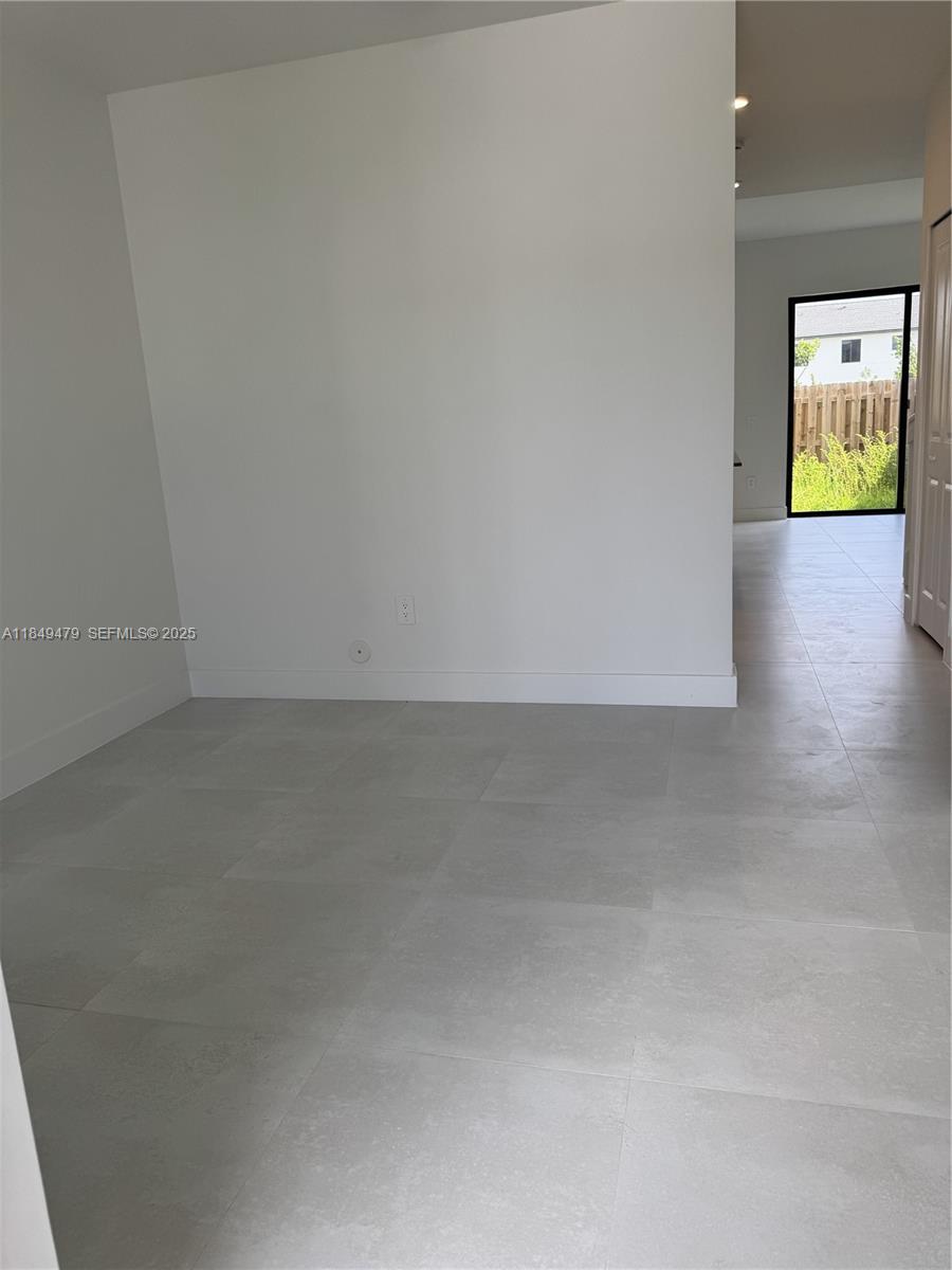 18963 Southwest 345th Terrace, Unit 18963 Homestead, FL 33034 - Photo 2 of 9 a view of an empty room