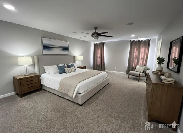a bedroom with a bed flat screen tv and couches