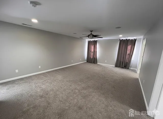 an empty room with stairs and wooden shelves