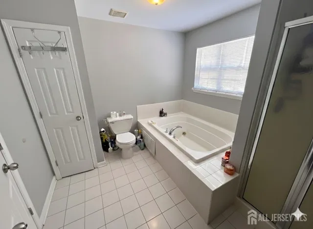 a white bath tub sitting next to a toilet
