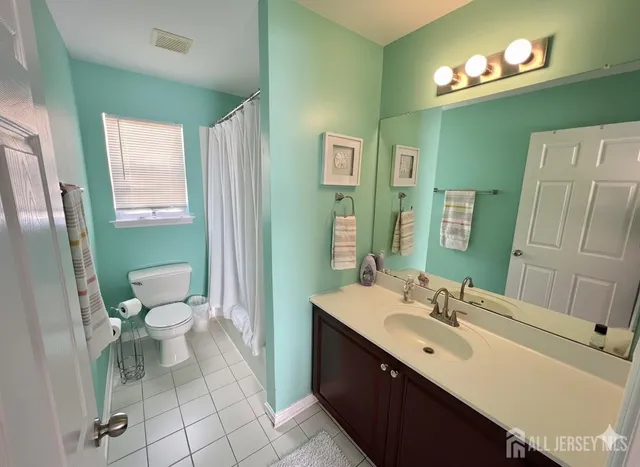 a bathroom with a sink toilet and a mirror