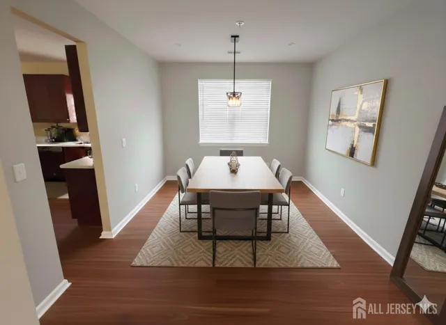 a dining room with wooden floor and window