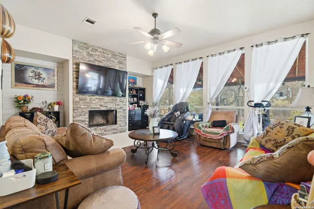 a living room with furniture a flat screen tv and a fireplace