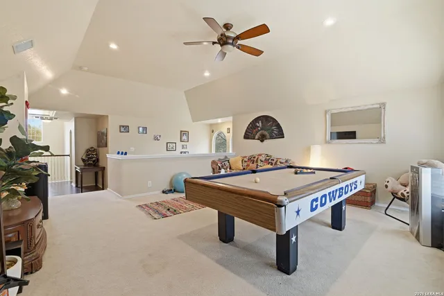 a bedroom with a bed and a mirror on dresser