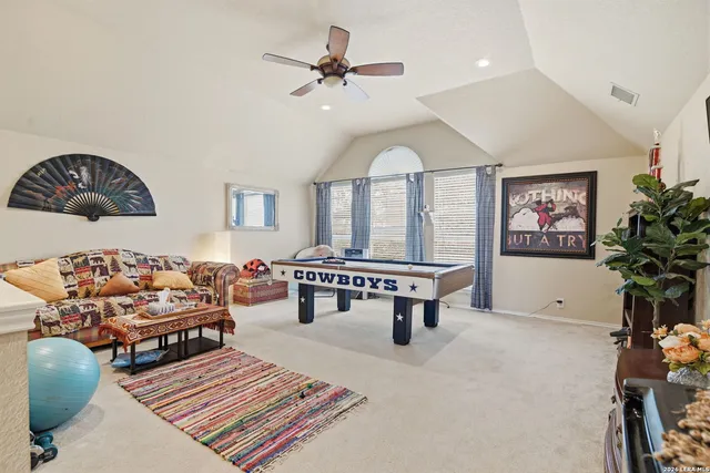 a view of a hallway with wooden floor and a living room