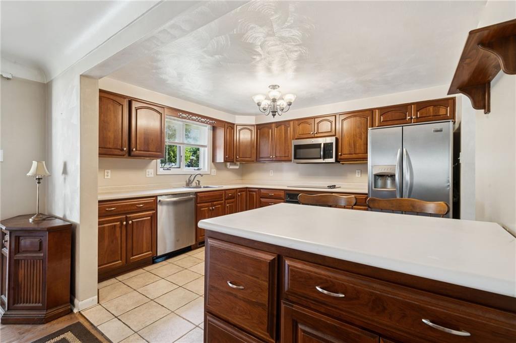 1722 Arona Road Irwin, PA 15642 - Photo 14 of 33 a kitchen with stainless steel appliances a sink stove and refrigerator