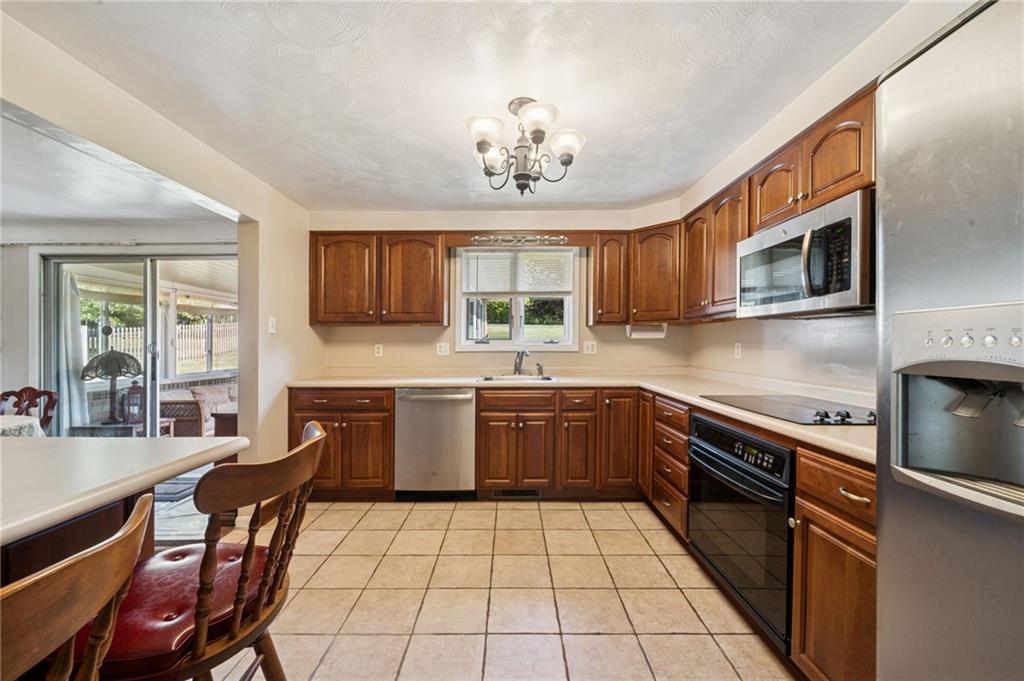 1722 Arona Road Irwin, PA 15642 - Photo 15 of 33 a kitchen with stainless steel appliances granite countertop a stove a sink dishwasher a microwave oven with granite countertops and cabinets