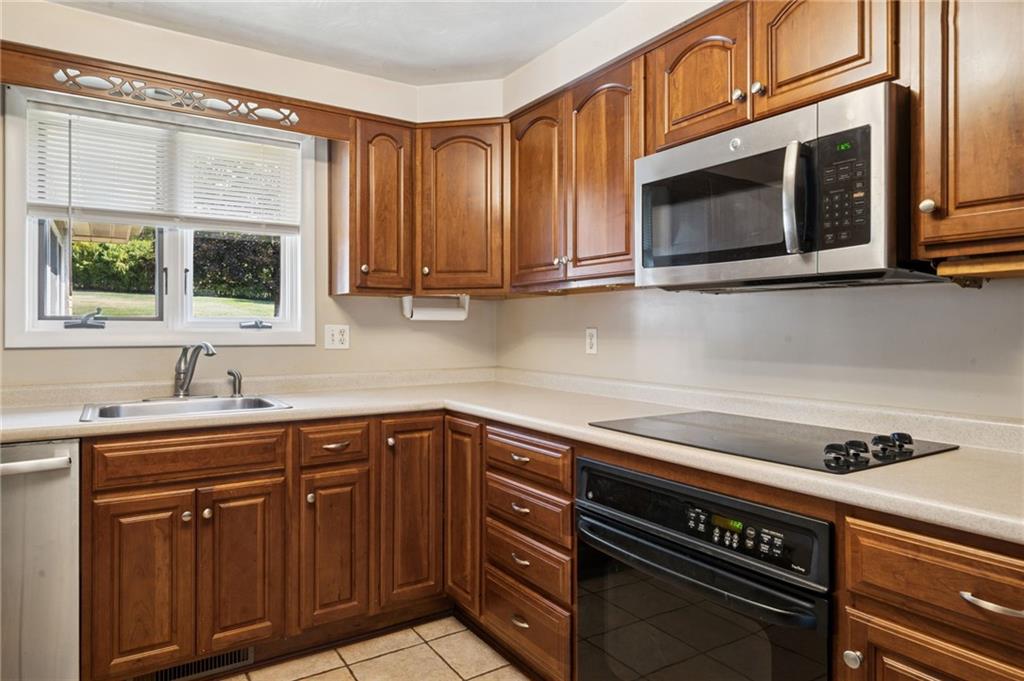 1722 Arona Road Irwin, PA 15642 - Photo 16 of 33 a kitchen with stainless steel appliances a stove microwave and sink