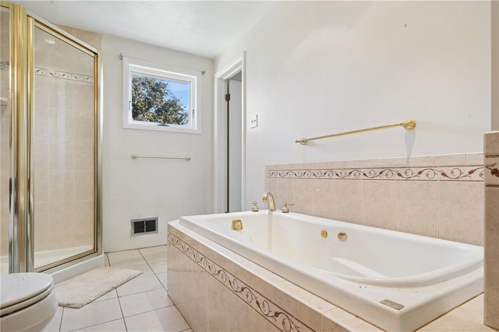 1722 Arona Road Irwin, PA 15642 - Photo 19 of 33 a bathroom with a bathtub and a shower