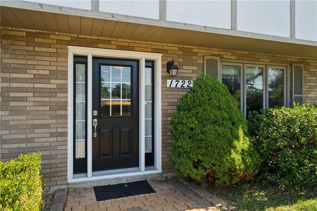 a view of a brick house with a large windows