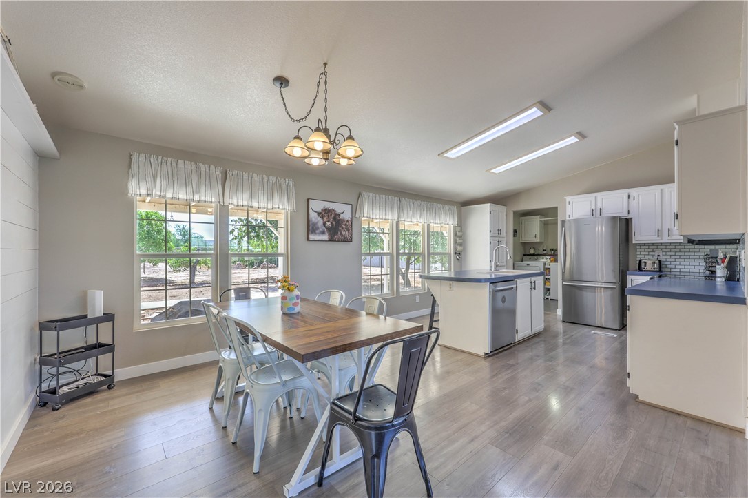 348 Tres Palomas Street Overton, NV 89040 - Photo 12 of 41 An inviting open-concept kitchen and dining area features abundant natural light and modern finishes.