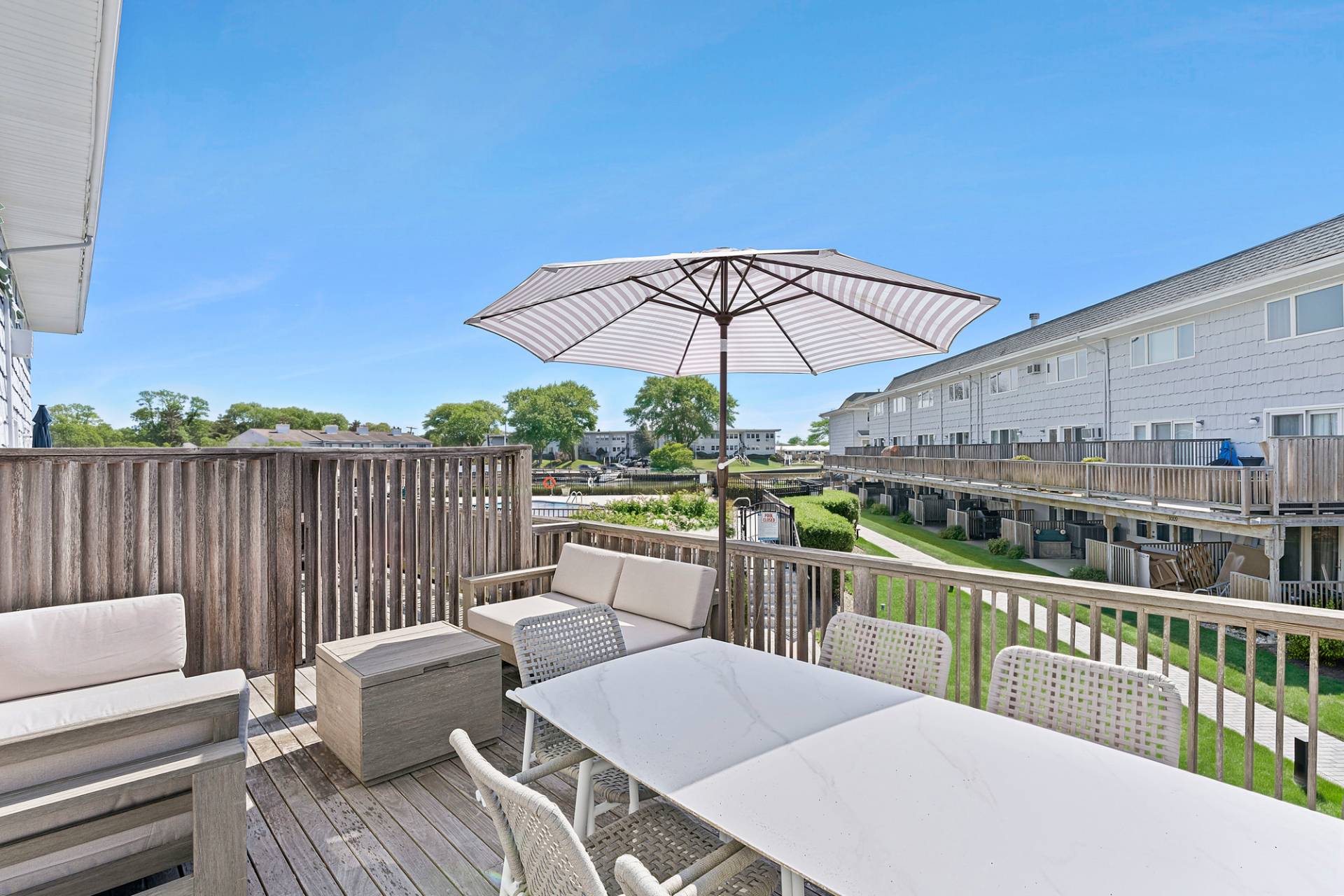 3004 Mitchell Road Westhampton Beach, NY 11978 - Photo 14 of 24 a view of a balcony with wooden floor and outdoor seating