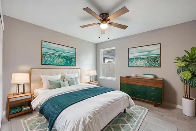 a bedroom with a large bed and a chandelier