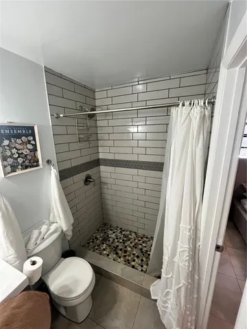 a bathroom with a toilet and a shower