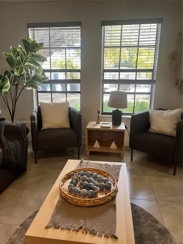 a living room with furniture and a large window