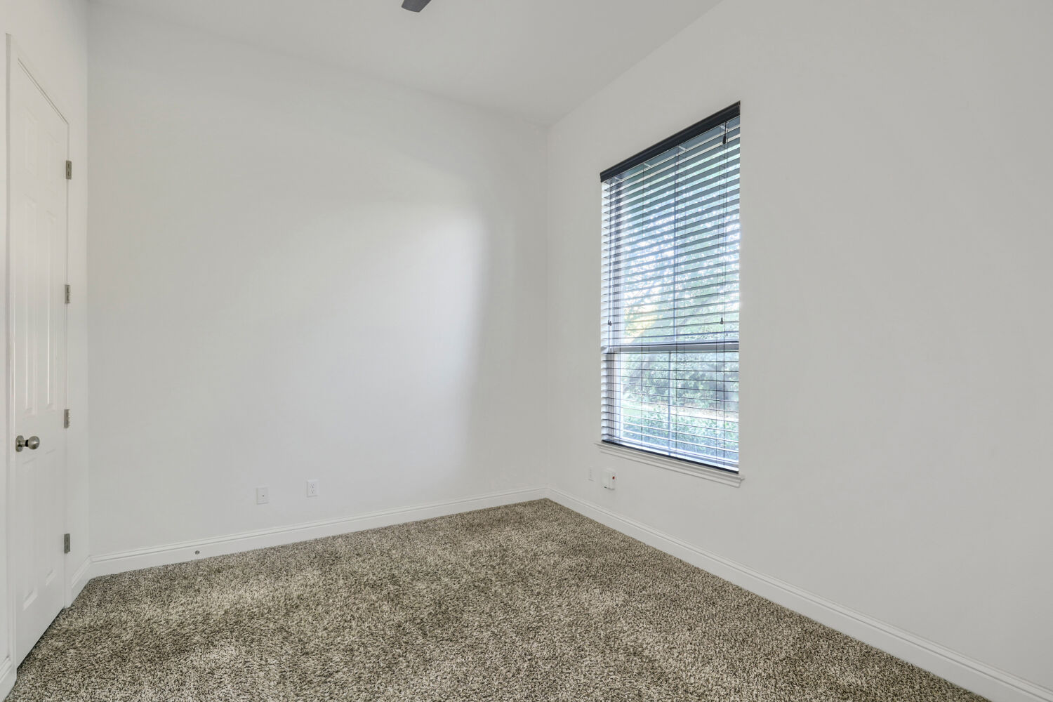 5821 Buchanan Draw Road Austin, TX 78738 - Photo 17 of 29 An inviting room features plush carpeting and a large window, offering ample natural illumination.