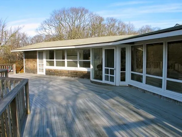 a view of a house with wooden floor and fence
